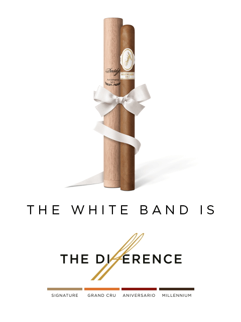 A Davidoff Aniversario No.1 Limited Edition Collection placed next to its wooden tubo wrapped with a white ribbon. 