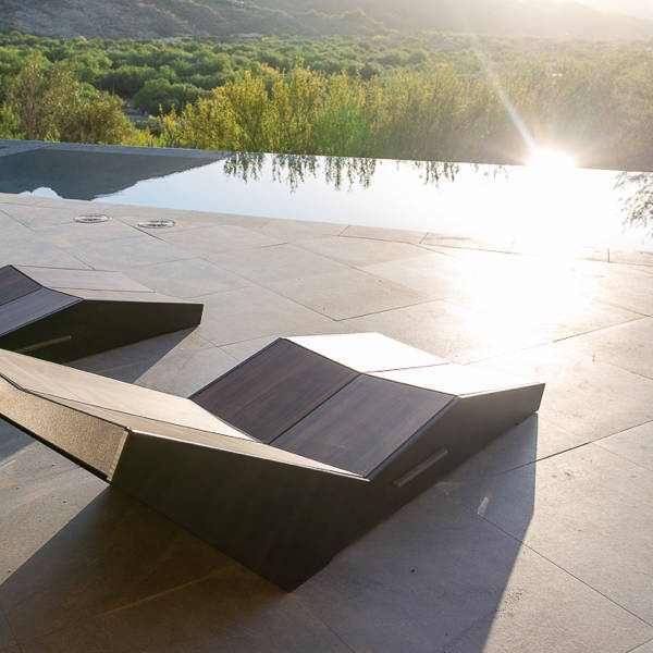 A chaise lounger that is made with three different wood grain colors.