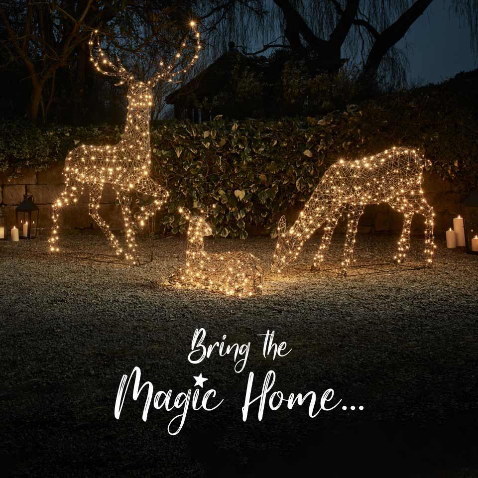 Bring the magic home. Light up reindeer family in a garden.