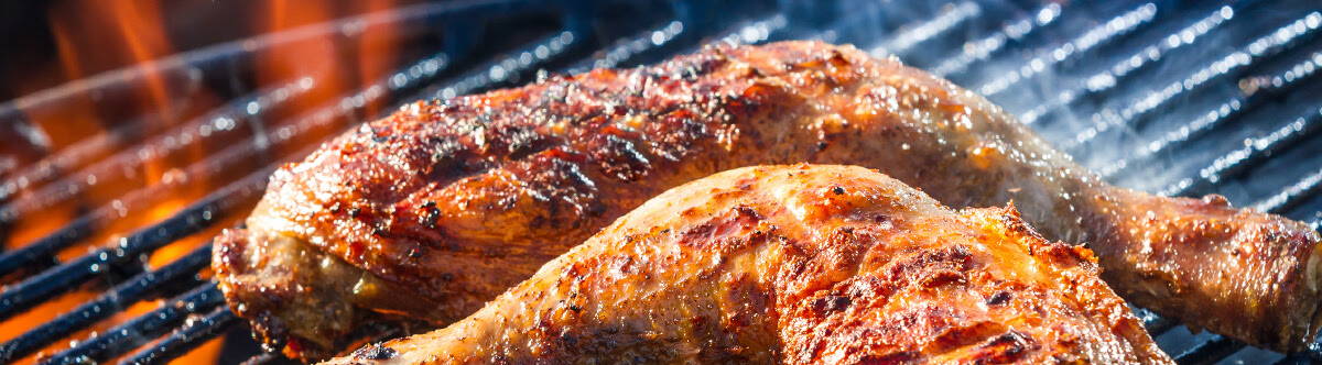 grilled chicken over a fire with grill marks