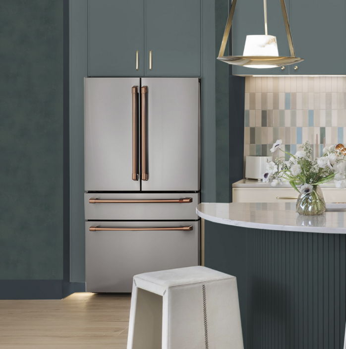 Modern kitchen with stainless steel refrigerator and stylish decor.