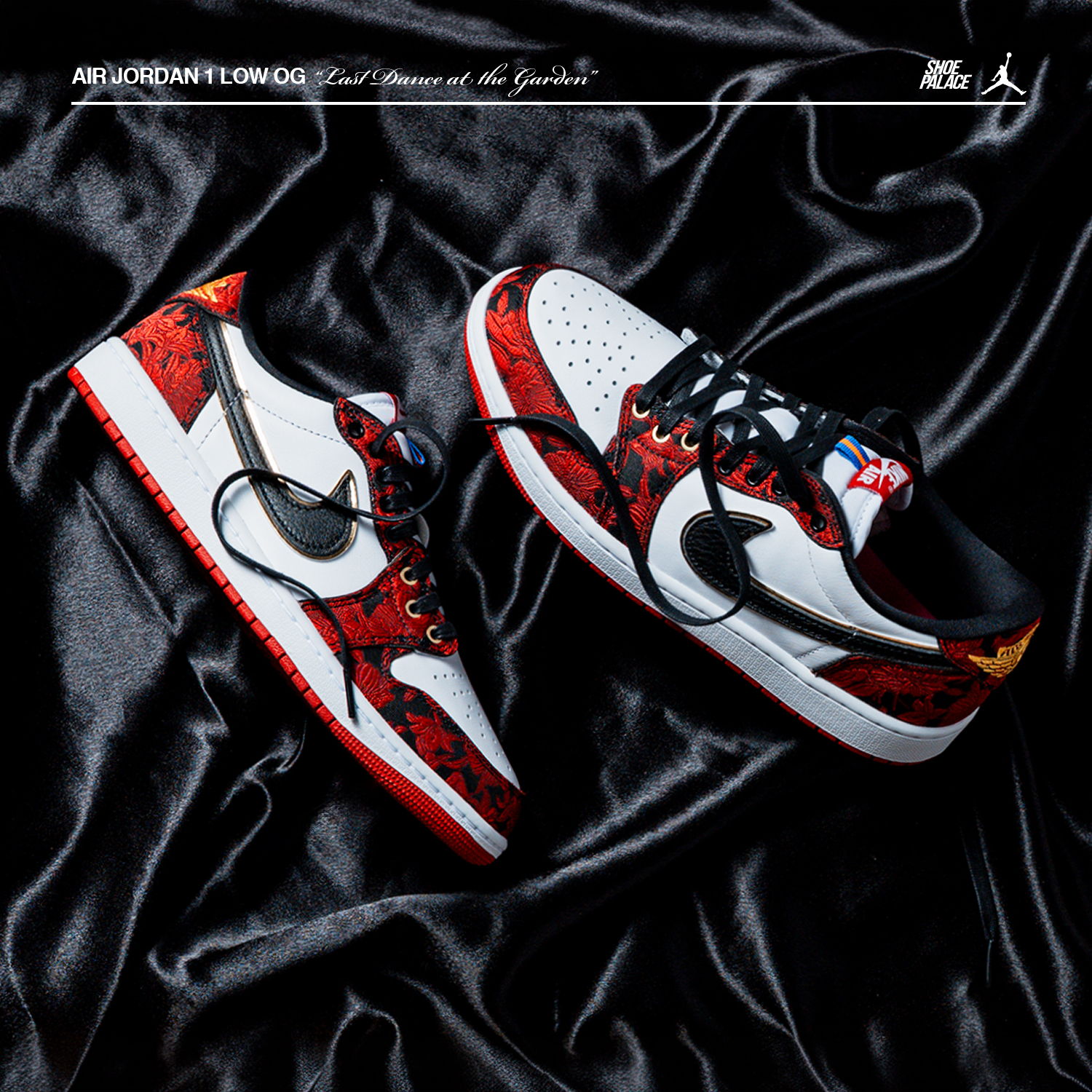 Nike sneakers on a black satin surface, featuring a red and white design.