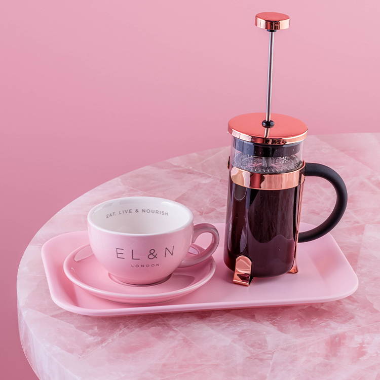 French press coffee with cup on pink 
