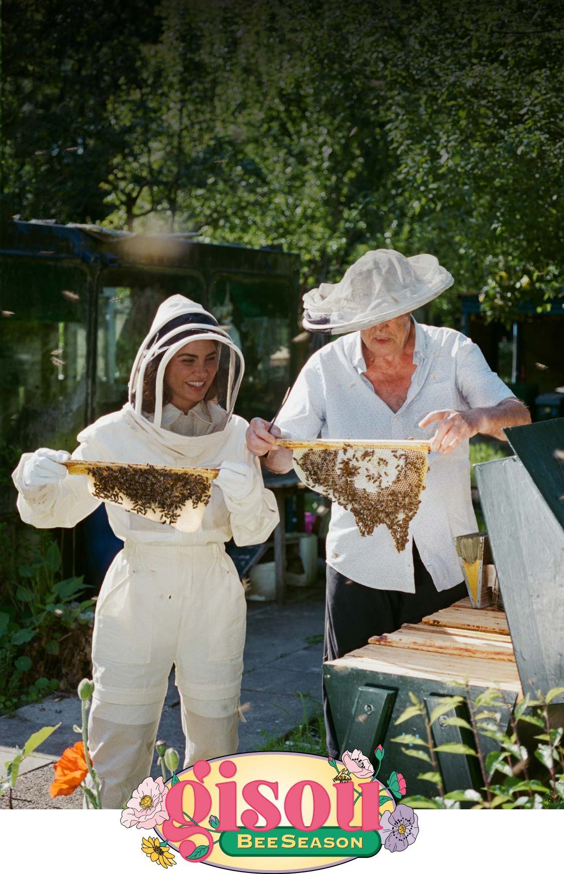 Negin and her dad holding bees in the Mirsalehi Bee Garden