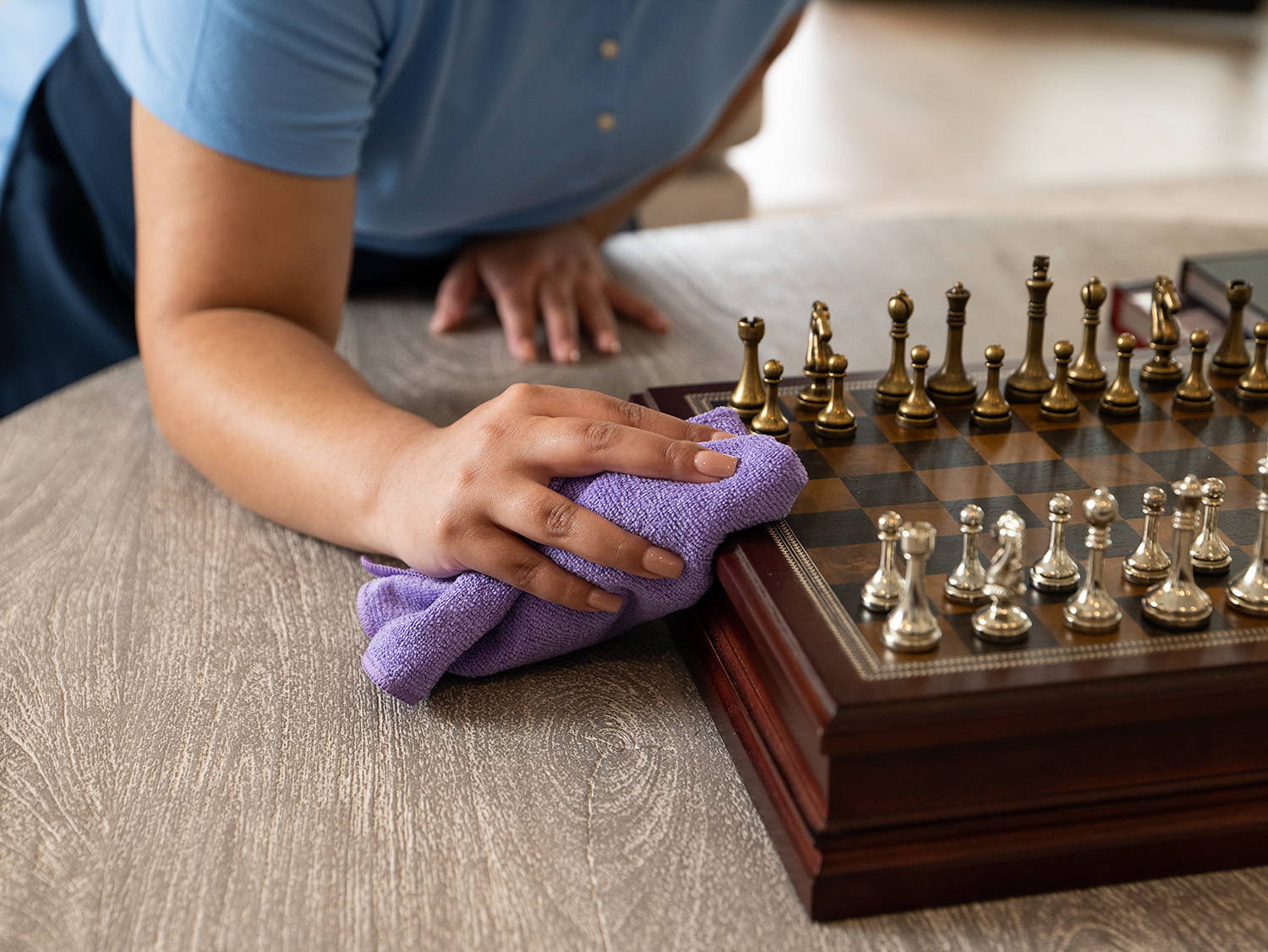 person wiping chess board with microfiber towel