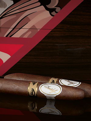 The Davidoff & Boyarde Masterpiece Humidor The Direct Gaze with two perfecto cigars placed in front of it. 