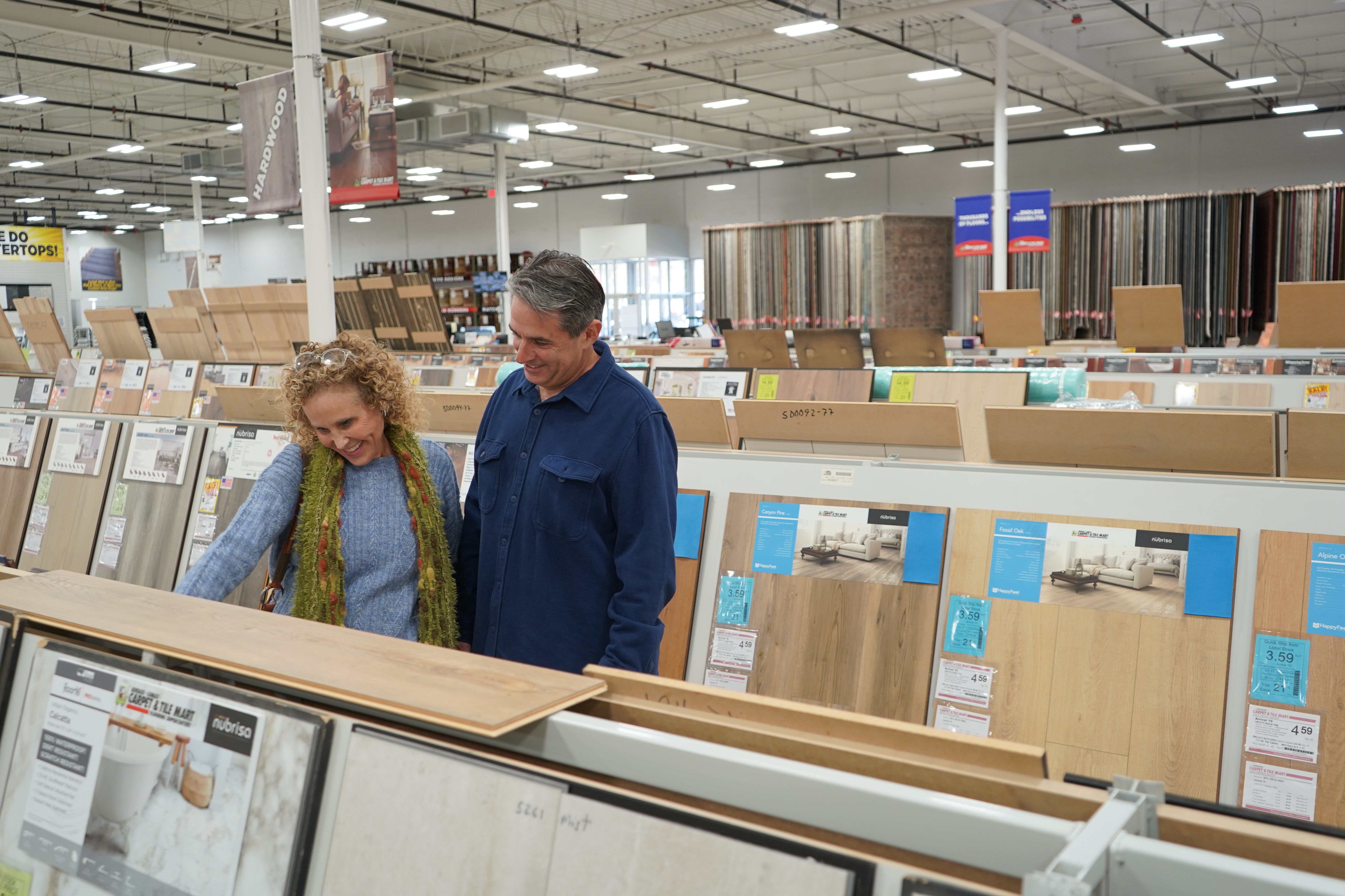 couple looking at flooring options at Carpet & Tile Mart