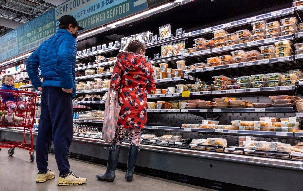Couple with toddler shop deli aisle