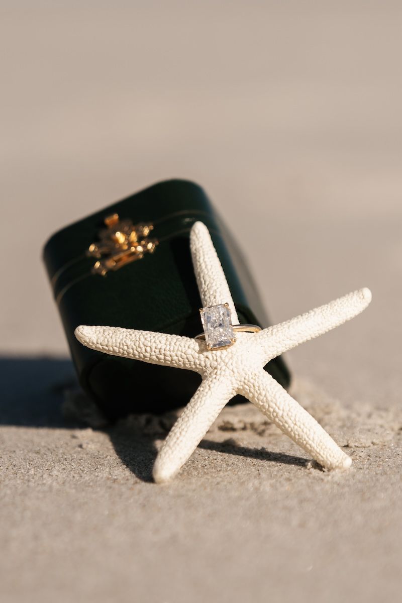 engagement ring on starfish on beach