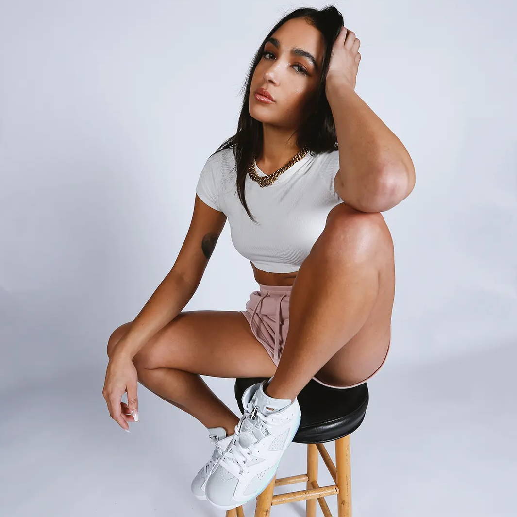 female model wearing sacre clothes and air jordan 6s