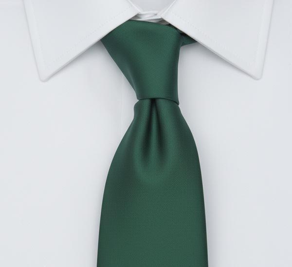 Four in hand tie knot tied a hunter green tie