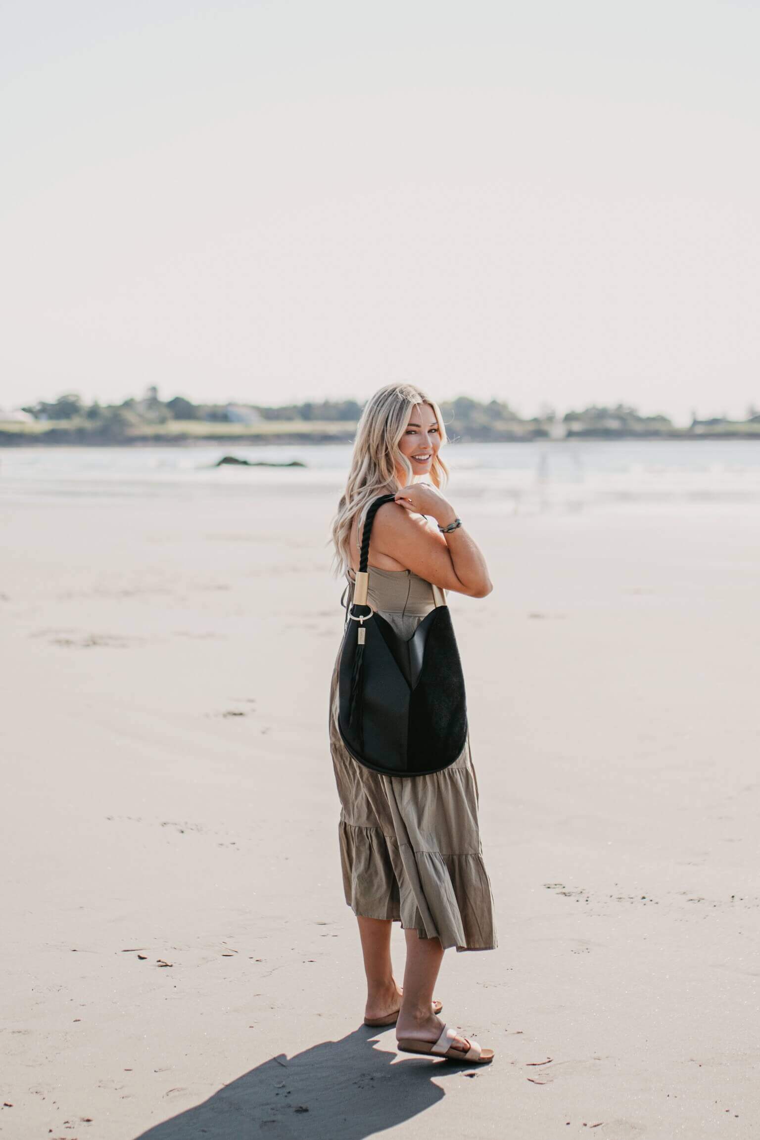 woman wearing black leather tote bag