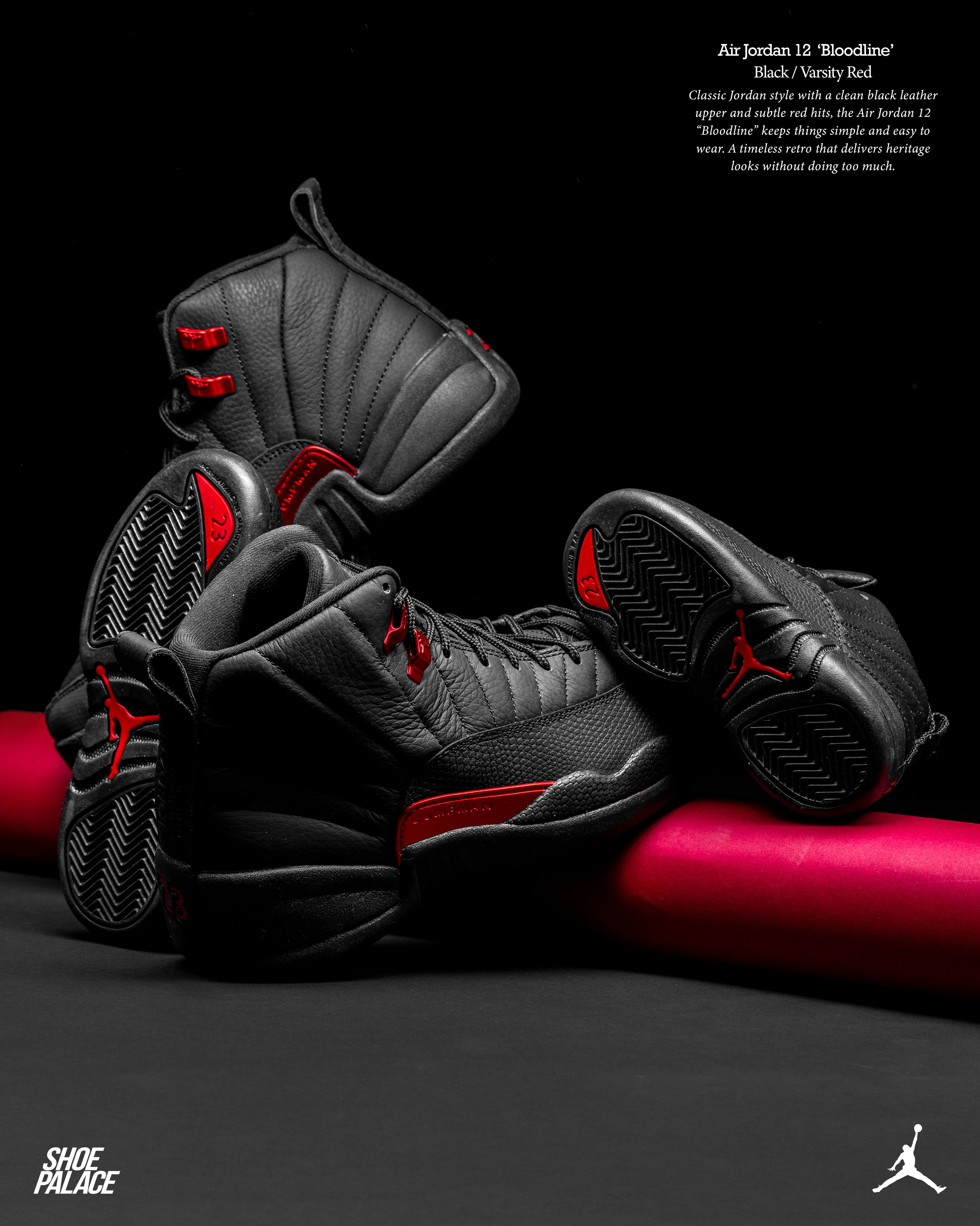 Black and red basketball shoes arranged on a black background.