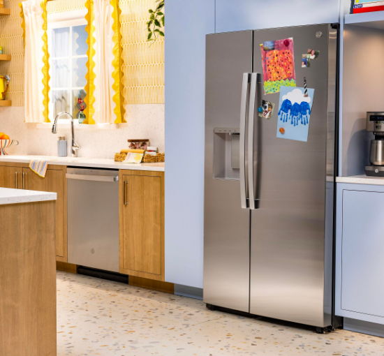 Modern kitchen with stainless steel refrigerator and wooden cabinets.