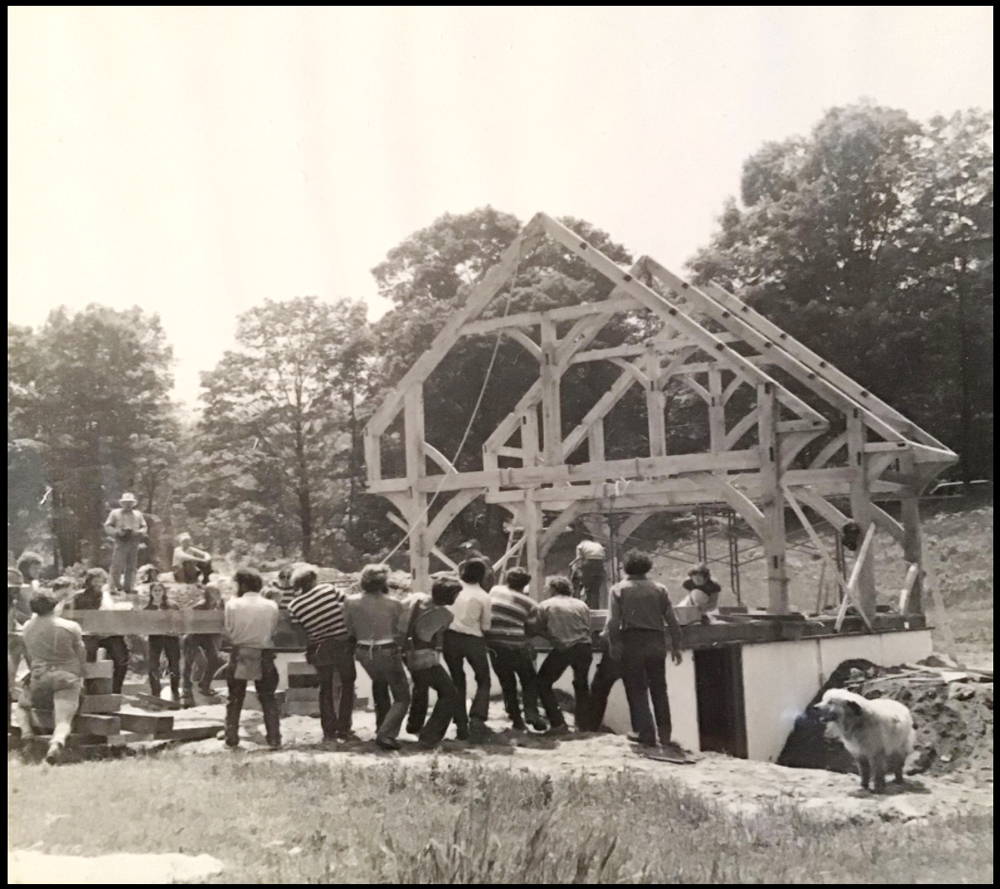 Historical photo of a building being built by the community
