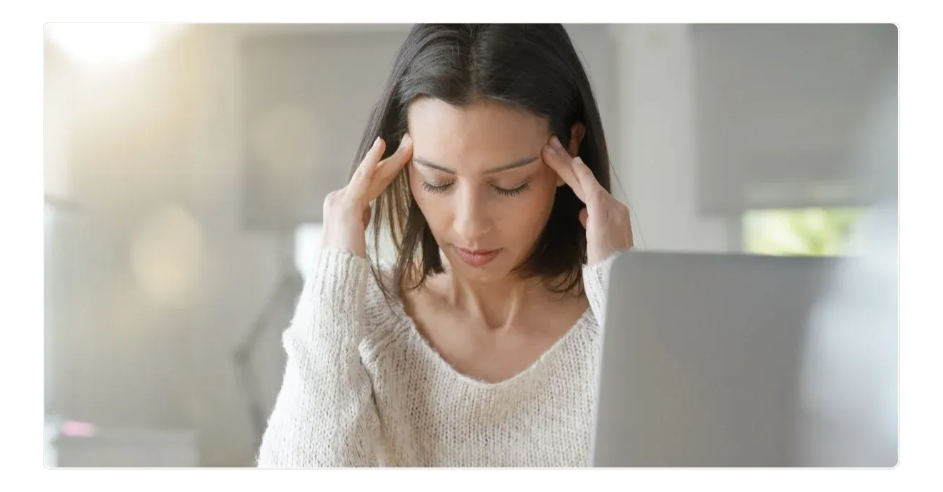 woman has a headache with her hand on temples 