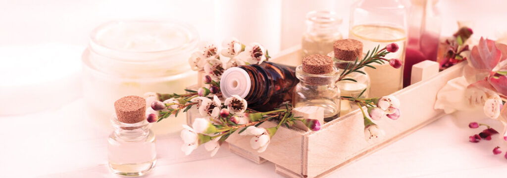 Decorative candles and flowers arranged in a soft, pastel-colored setting.
