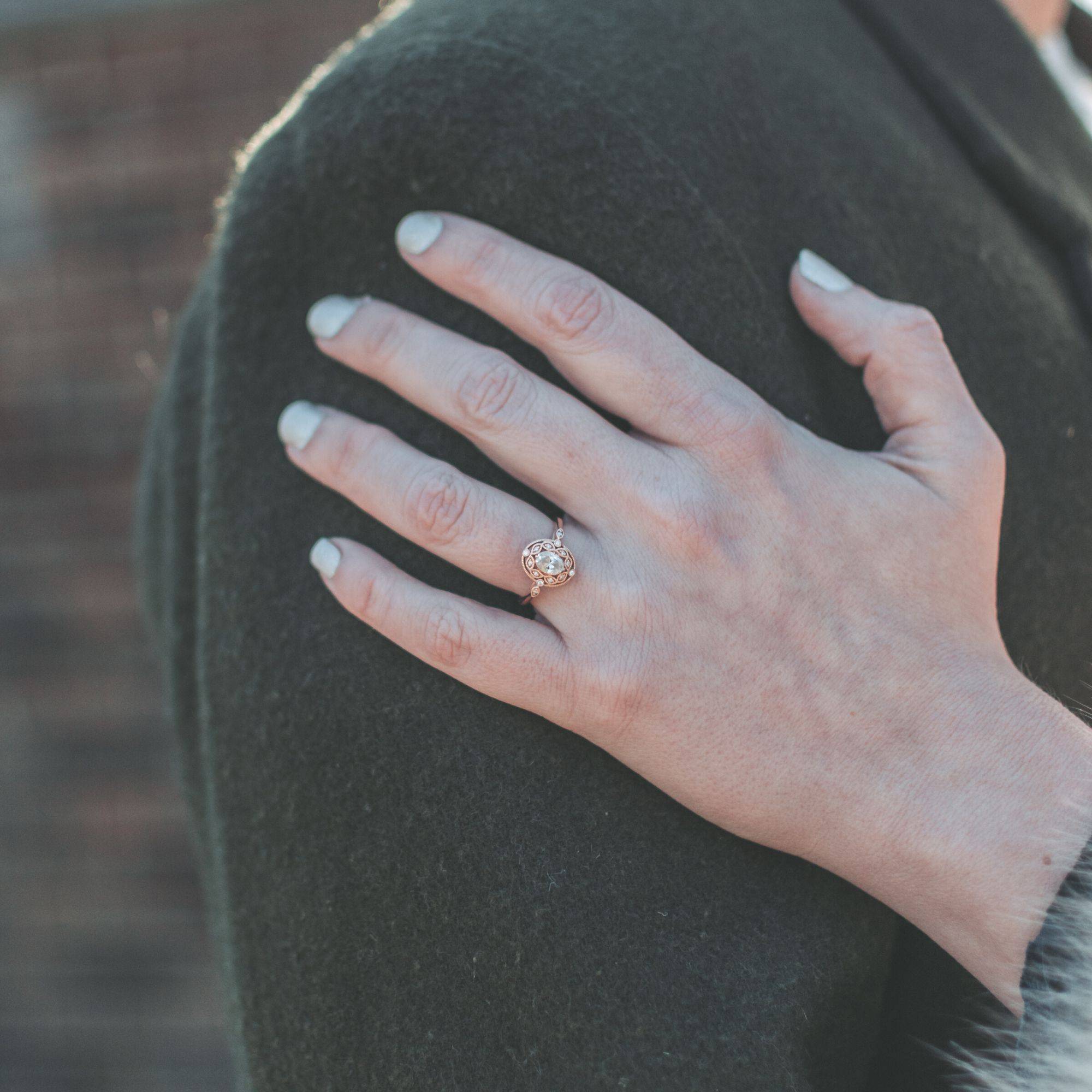 14K rose gold oval diamond engagement ring with milgrain and diamond halo