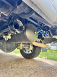 Undercarriage view of black air tank and twin train horns with blue air lines mounted to chassis