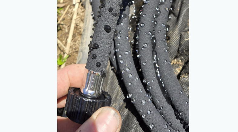 Close-up of textured black hose with a metal connector.