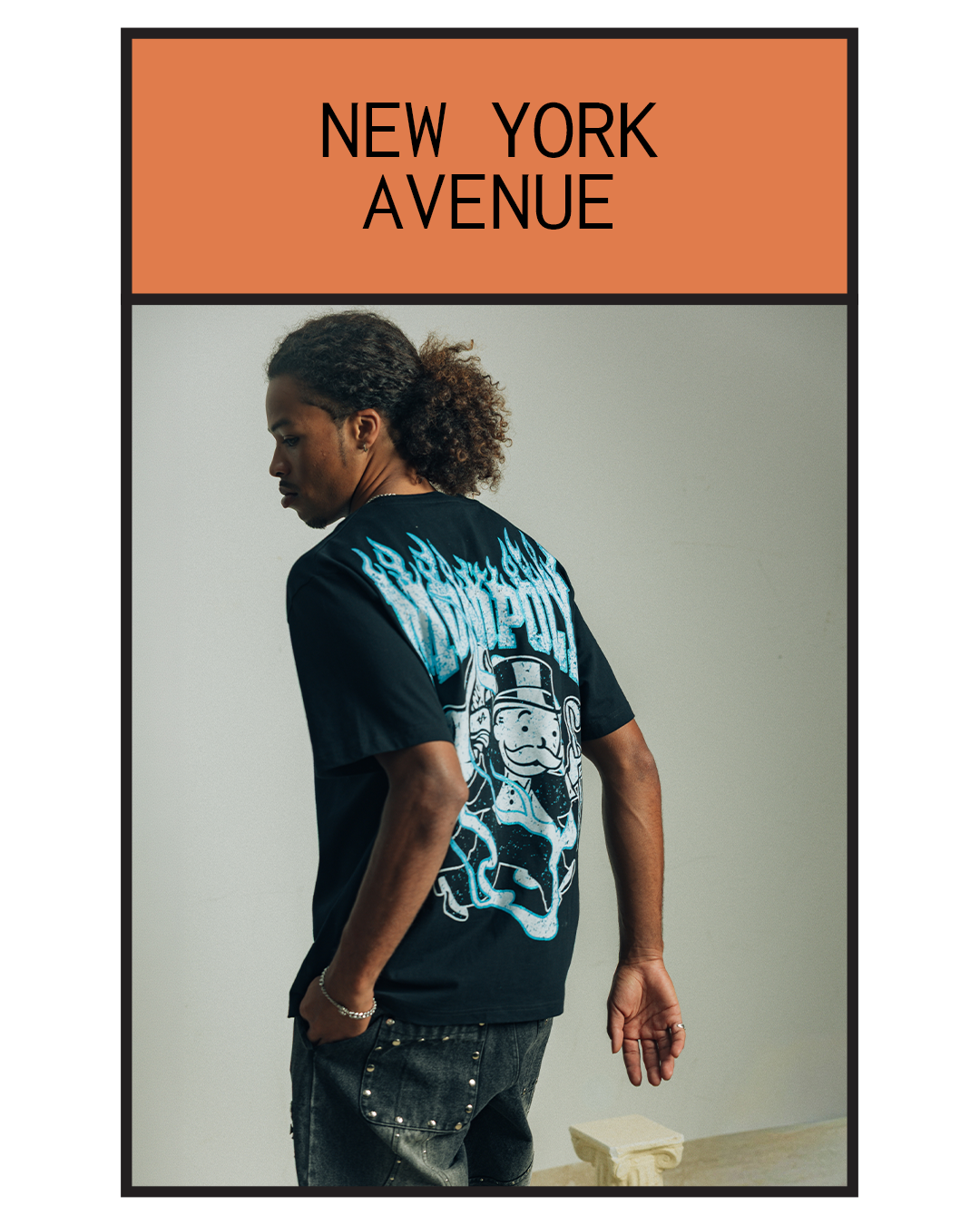 Person wearing a black t-shirt with graphic design, facing away.