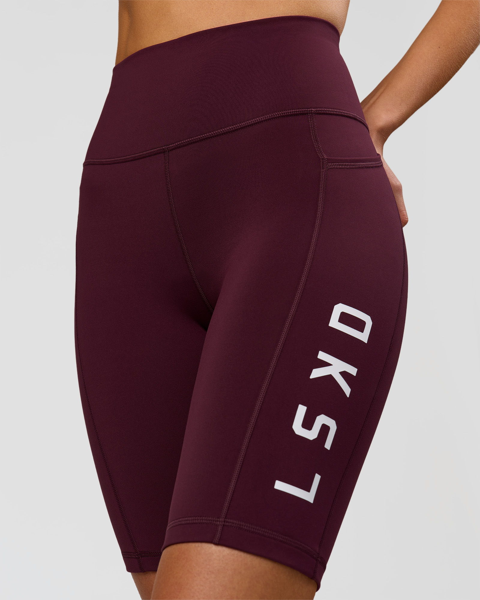 Maroon athletic shorts with white branding on the side.