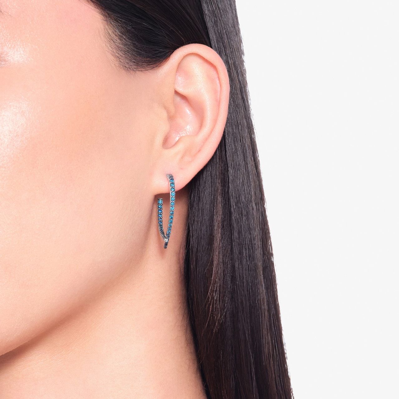 Model wearing a blue diamond hoop earring
