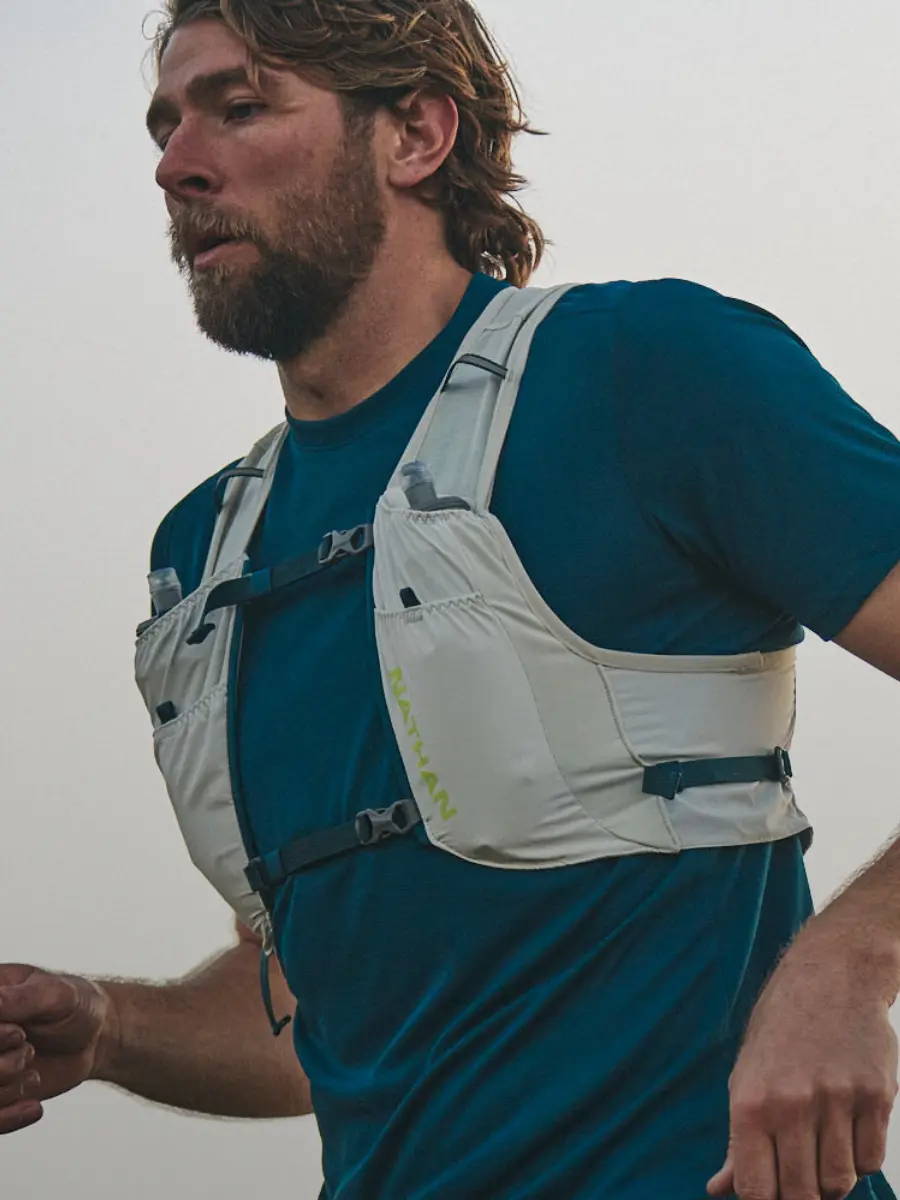 Male runner wearing a Nathan hydration vest.