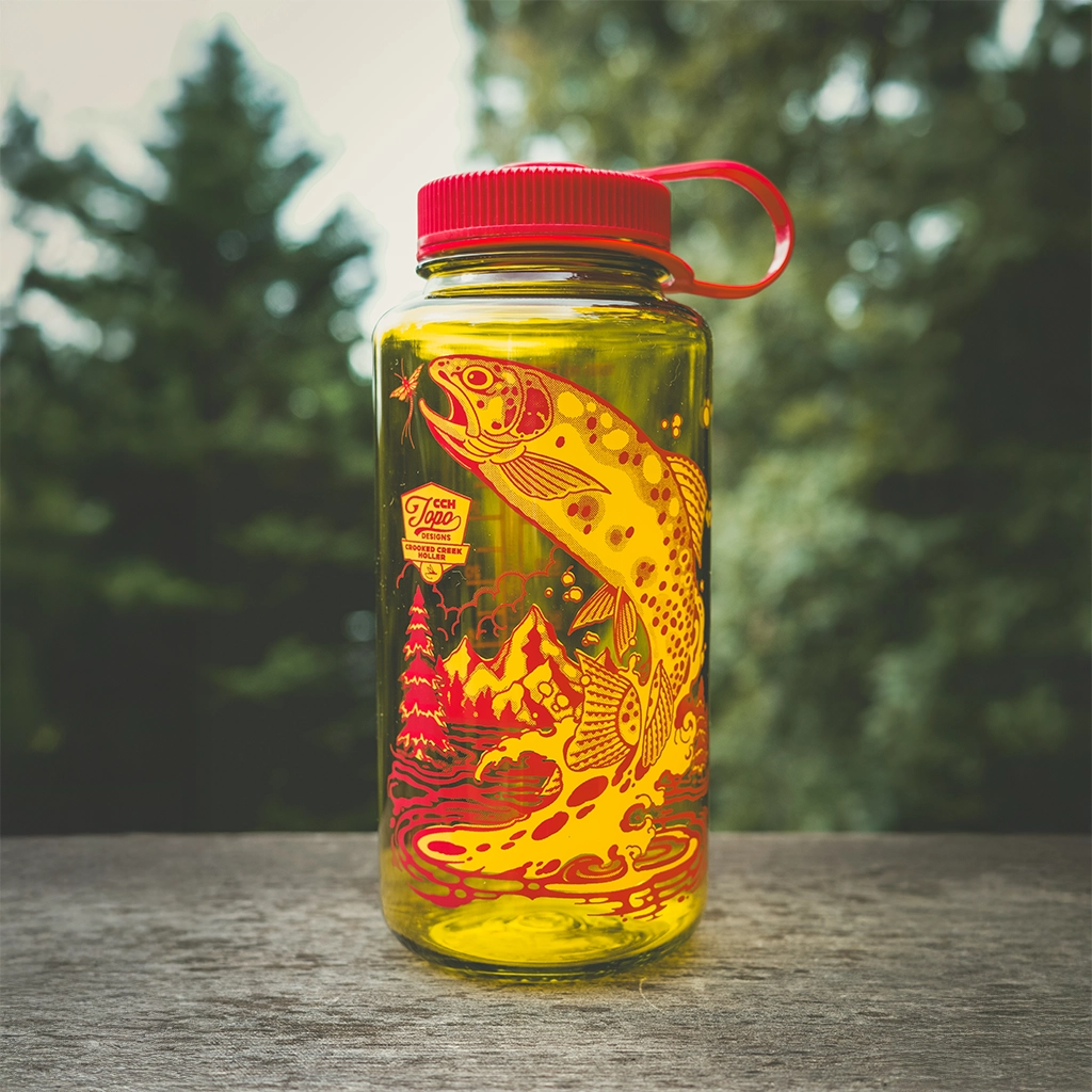 A yellow water bottle with a fish design and red lid.