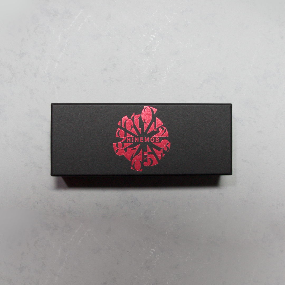 Black box with a red floral design on top.