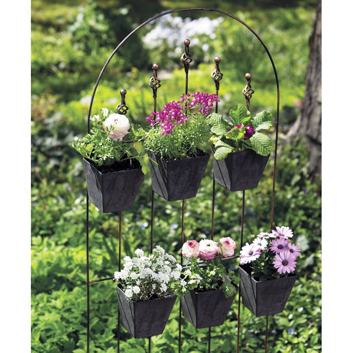 6 small black wall planters mounted to a trellis