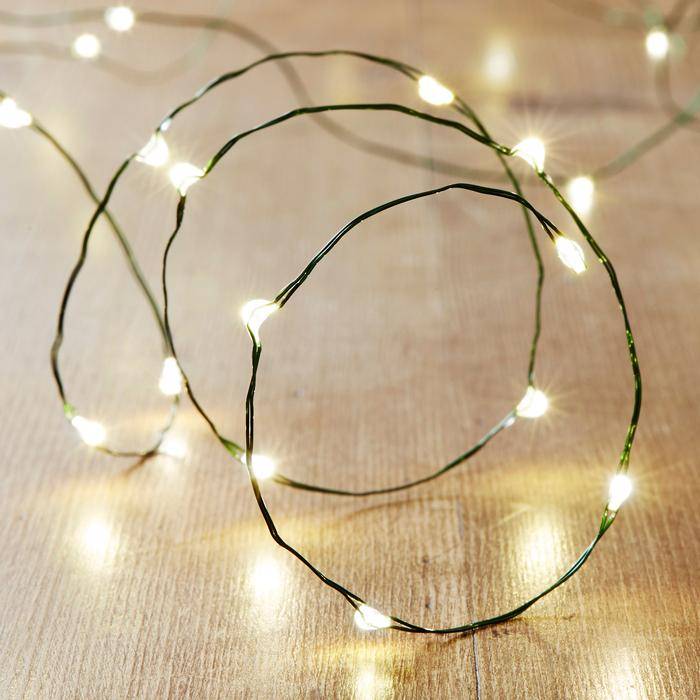 Warm white LED micro lights with green wire illuminated on table