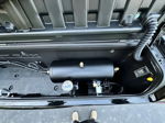 Top-down view of HornBlasters air tank and compressor installed inside black storage compartment