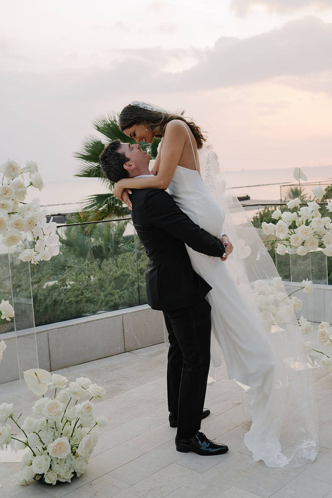 Groom lifting up the bride with romance