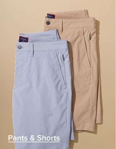 Two pairs of pants in light blue and beige on a neutral background.