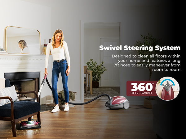 Woman vacuuming a room with a swivel steering vacuum cleaner.