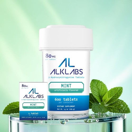 Mint tablets from ALKLABS with mint leaves in the background.