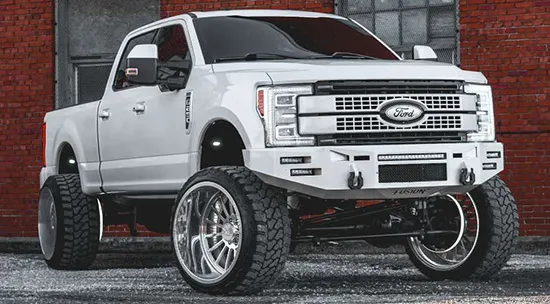 Holden's lifted white 2017 Ford F250 Super Duty with custom front bumper and chrome wheels