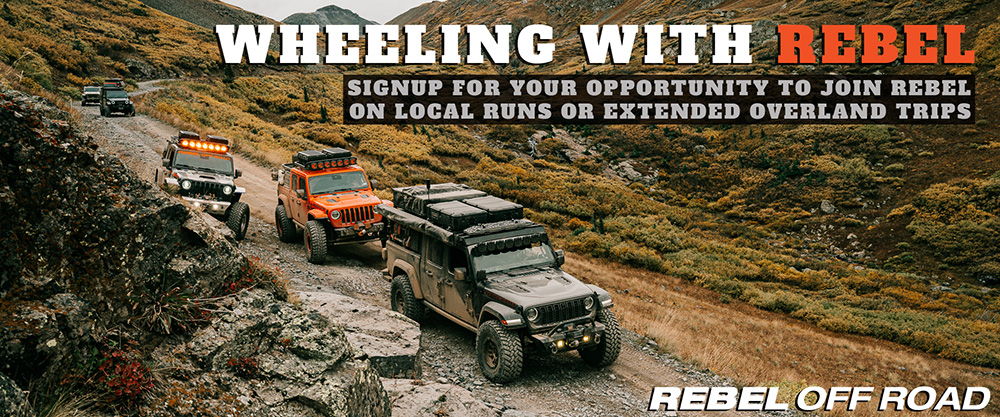 Off-road vehicles driving through a mountainous terrain with promotional text.