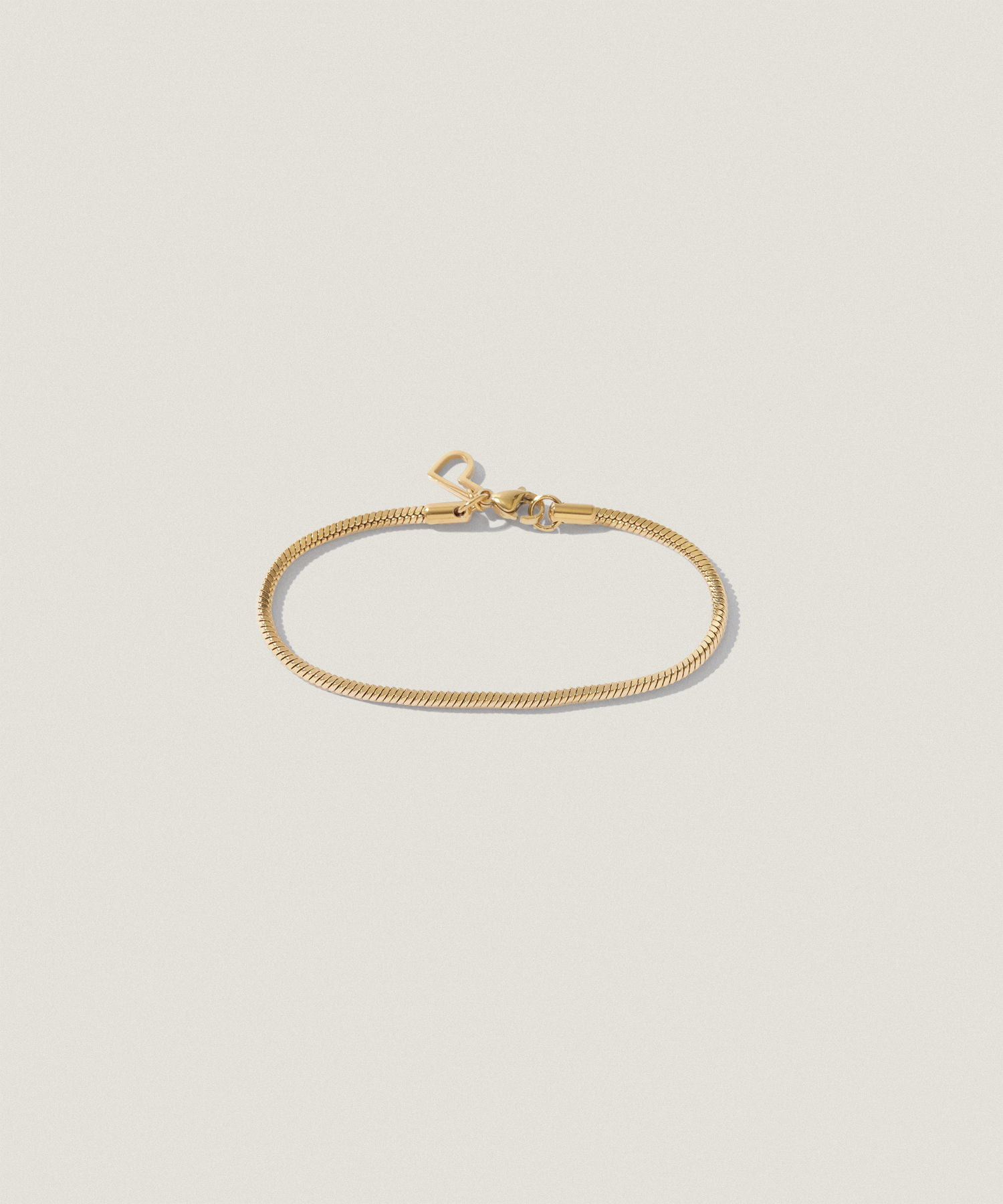 Gold bracelet on a light background.