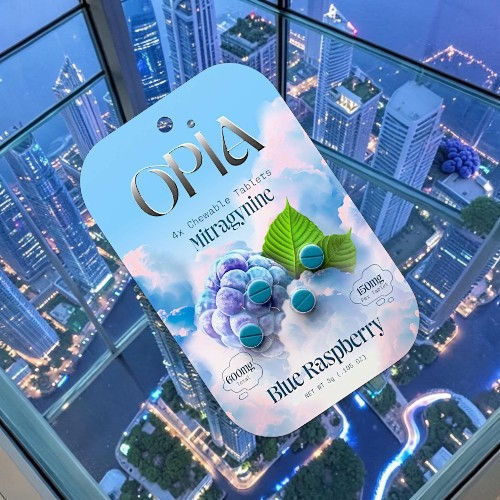 A product packaging featuring a blue raspberry design against a city skyline background.