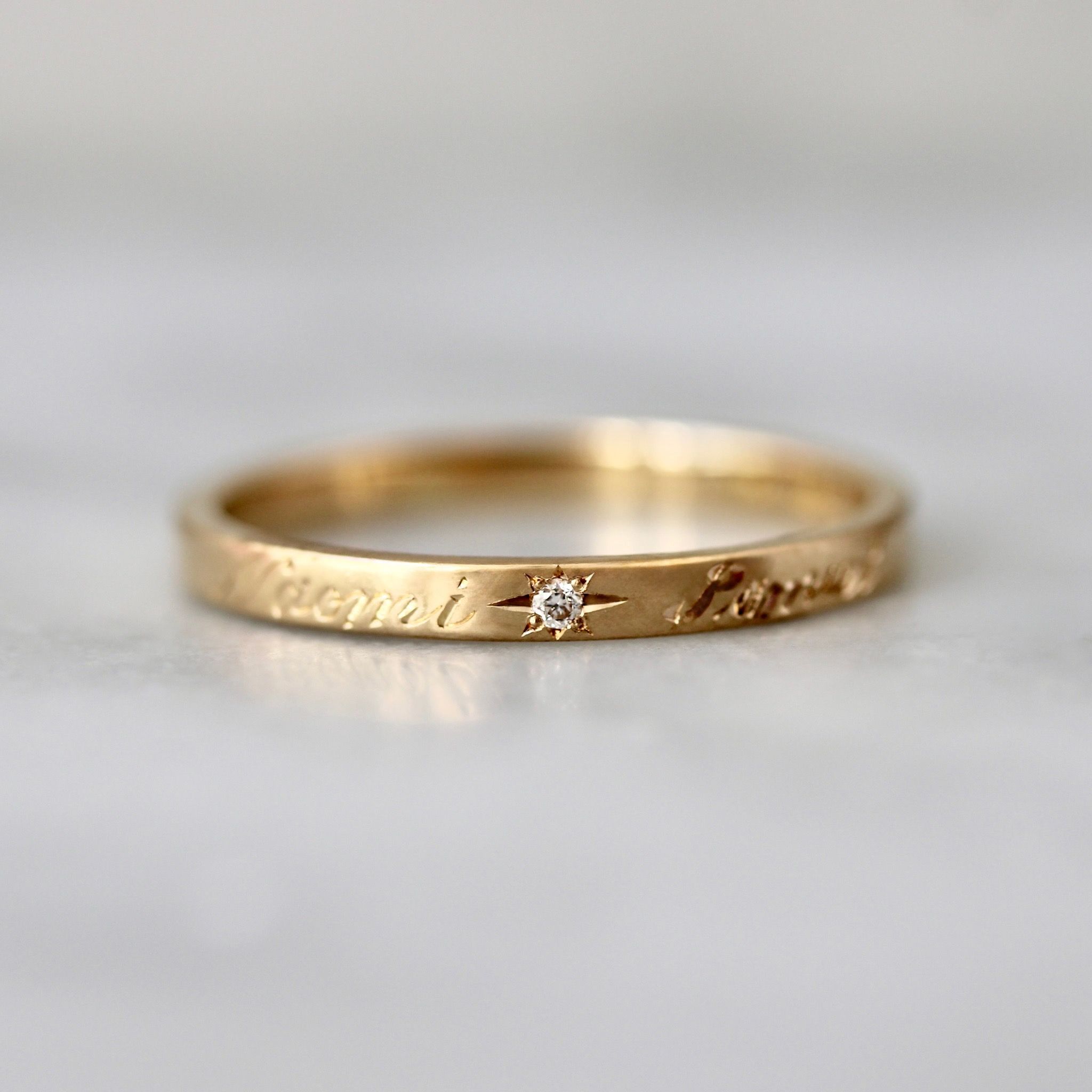 Hand-engraved-ring-with-diamond-cursive-on-outside-of-band