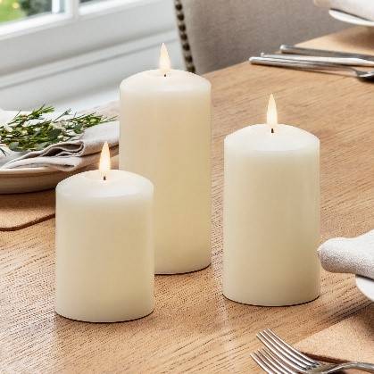A classic trio of TruGlow® flameless candles on a table setting