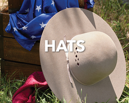 A large beige hat on grass with a blue star-patterned cloth.