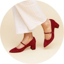 A pair of red heels worn with white pants.