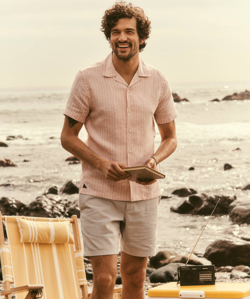 Model is wearing UNTUCKit Lenora button down and Whitley drawstring shorts. 