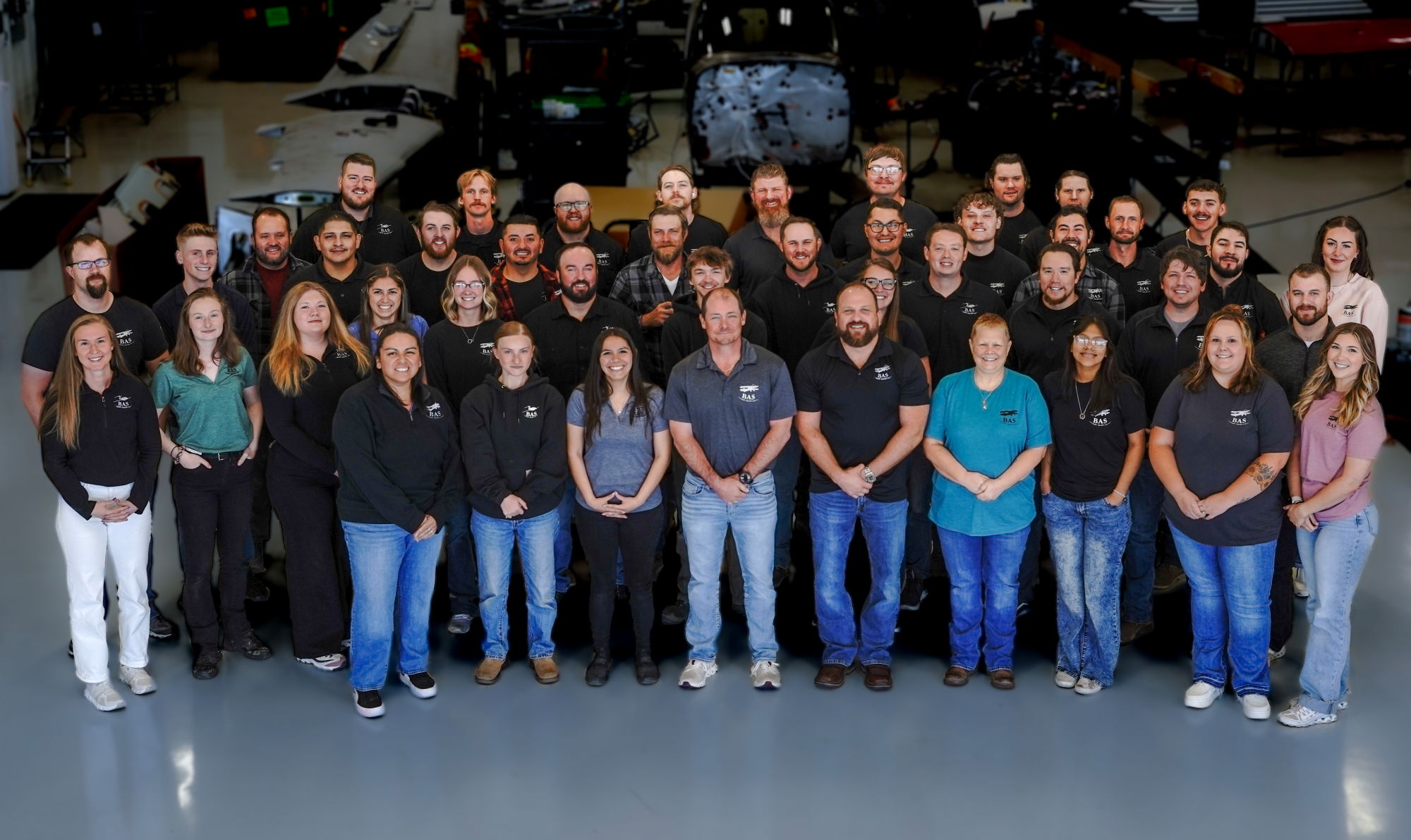 A group photo of many people standing together in a large indoor space.