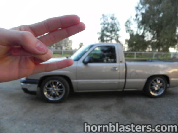 Creative shot of Thomas's silver 2005 Chevy Silverado 1500 with hand gesture in the foreground, install photo 14