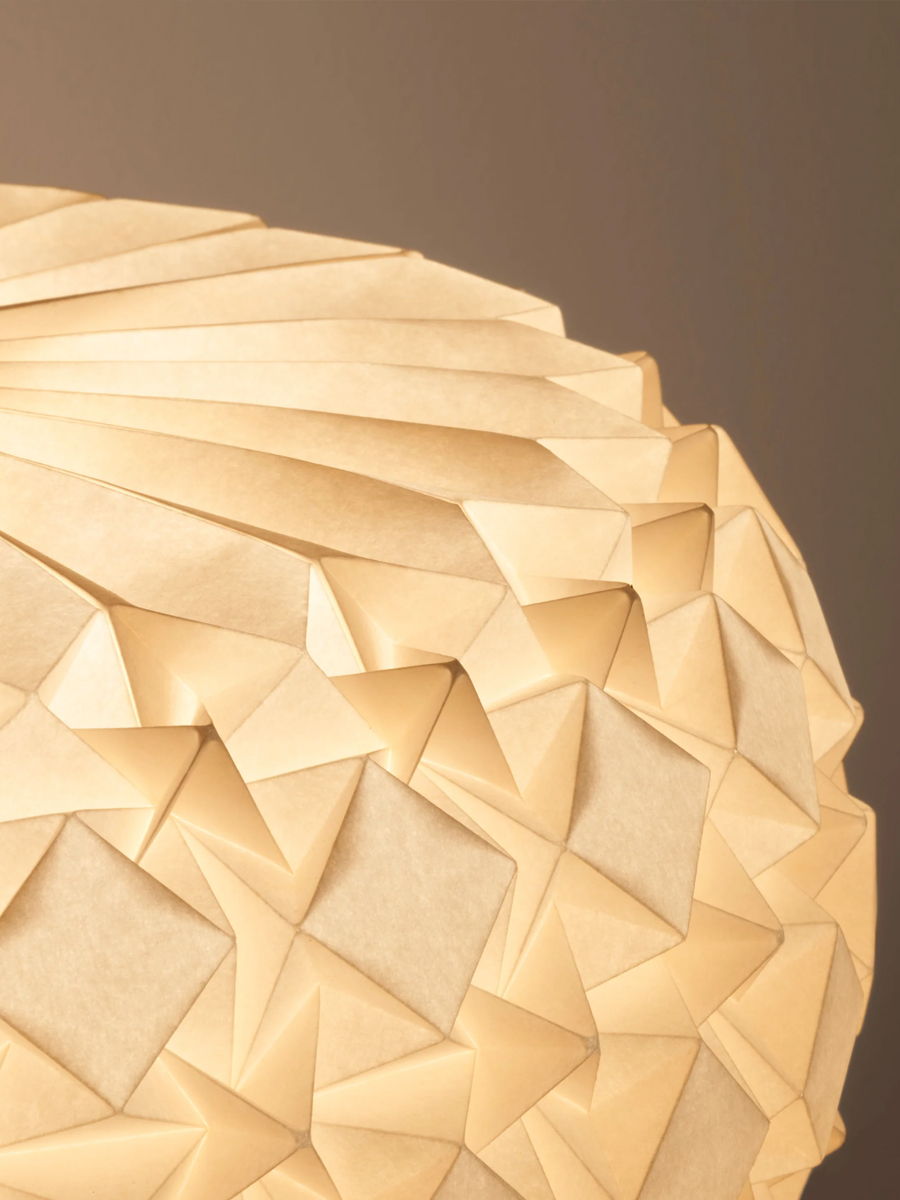 Close-up of a textured, geometric paper lamp shade.
