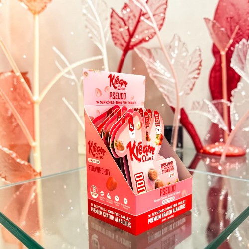 Kiss My Keto product display on a glass table with decorative leaves.